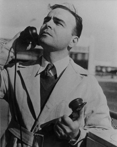 Joe Ables, operations manager, listening to planes as they fly over United Airport above the fog, ca. 1932