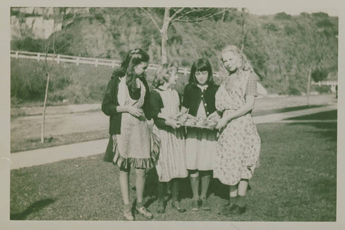 Girls holding a tray of bake sale goods for Canyon School in Santa Monica Canyon
