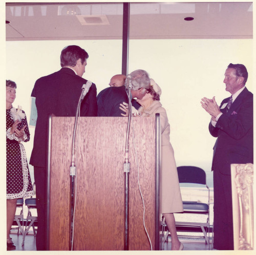 Senator Goldwater kissing Mrsd. Seaver, Lawrence Welk behind them