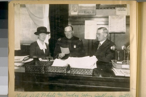 Chief D.A. White and Judge John Sullivan with a lady worker talking over a case, 1917