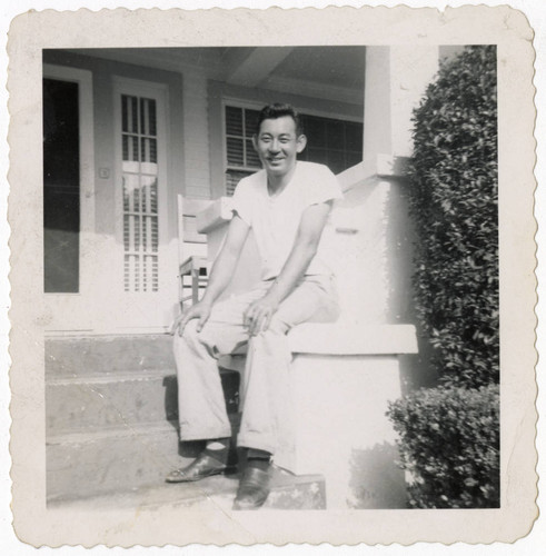 Minoru Frank Saito sitting on front porch