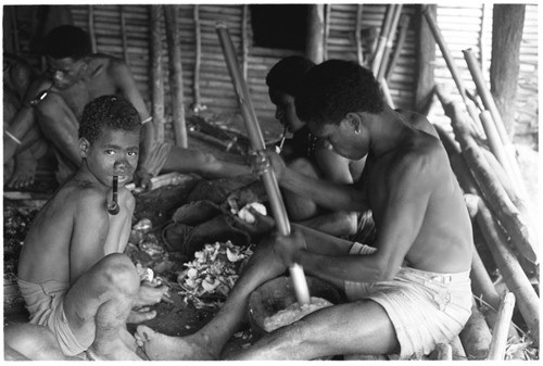 Men pounding taro and coconut pudding