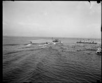 View from a pier toward water skiers and a swim platform, San Diego vicinity, 1920-1930