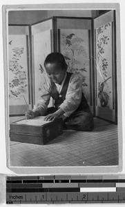 Boy seated in front of painted screen, Yeng You, Korea, 1926