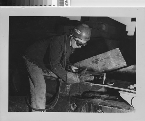 [Photograph of female shipyard welder]