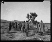 Men investigate an area of the Mojave Desert in search of the remains of murder victims of Gordon Stewart Northcott, Rivrside County, 1928-1929