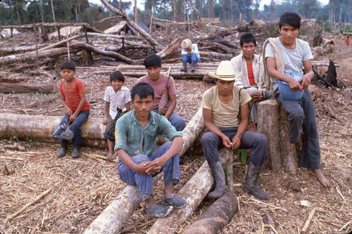 Male Guatemalan refugees sit outdoors, Chajul, ca. 1983