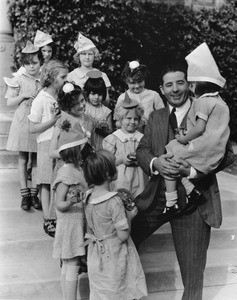 Judge Marchetti with little girls from Los Angeles Orphanage, at New Year celebration, 1935