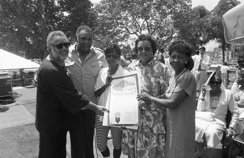 Dorothy Height and others holding a proclamation at the Black Family Reunion, Los Angeles, 1989