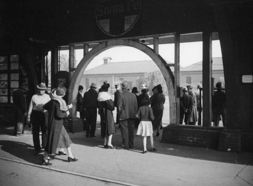 Crowds wait under an arch at La Grande Station