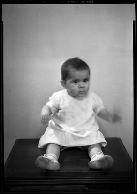 Portrait of baby boy sitting on table