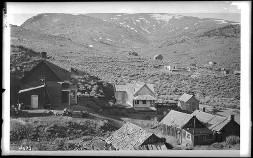 Cabins or cottages scattered across an unidentified mountain valley, California
