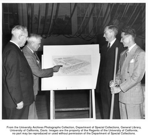 Groundbreaking for Haring Hall, Governor Warren, Dean Claude Hutchison, and University of California President Robert Gordon Sproul look at an architectural drawing of Haring Hall