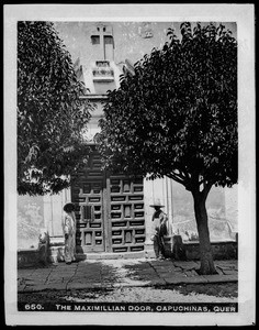 Two men at the sides of the door (the "Maximillian door") to the Convent of Capuchinas, Queretaro, Mexico, ca.1905-1910