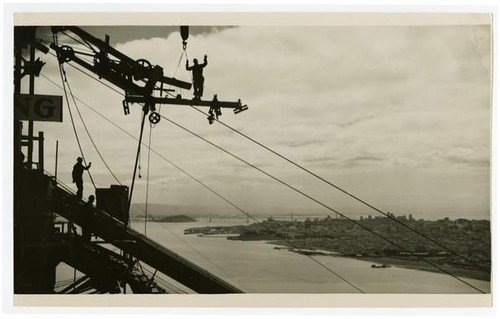 Golden Gate Bridge construction workers spinning cable with view of San Francisco