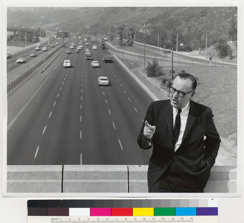 Governor Edmund G. Brown speaking in front of a freeway