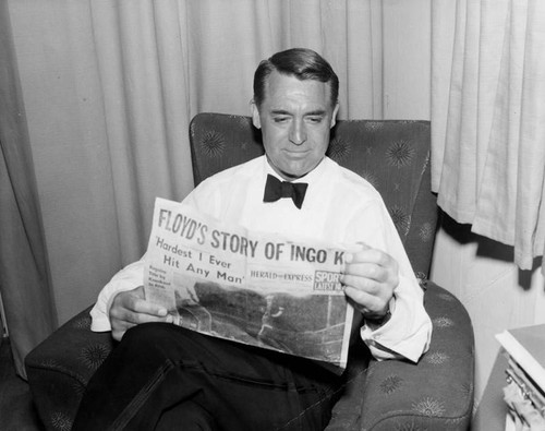 Cary Grant reads the Herald-Express