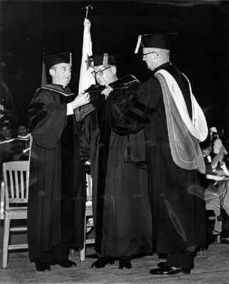 [Father Connolly (left) confers law degree upon Governor Edmund G. Brown (center)]
