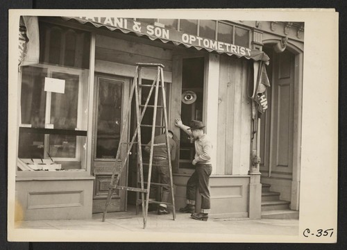 San Francisco, Calif. (Post Street). Owners of Japanese ancestry board windows of their stores prior to evacuation. Evacuees will be housed in War Relocation Authority centers for the duration. Photographer: Lange, Dorothea San Francisco, California