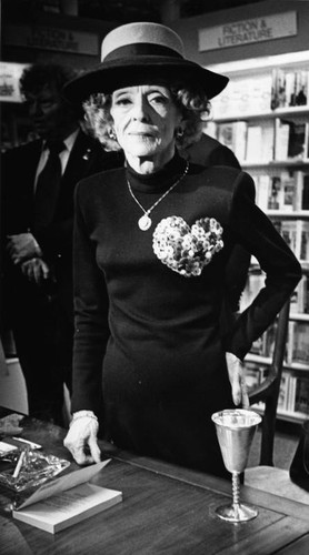 Bette Davis behind book signing table