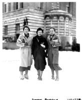 Snowfall on campus - Three female students standing in front of Education Building (Moore Hall), 1932