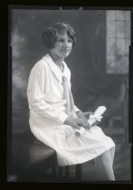 Portrait of young woman with rolled document, c. 1928