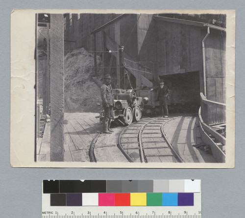 Two men standing next to a coal car, Tesla Coal Mines, California. [photographic print]