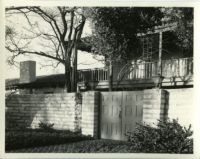 Rancho Los Cerritos, view towards gate, wall and house from forecourt after restoration, Long Beach, 1931