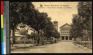Brick church standing at the end of a tree-lined avenue, Elisabethville, Congo, ca.1920-1940