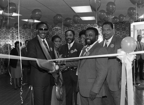 Chicken George ribbon cutting participants posing together, Los Angeles, 1985