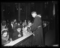 Catholics receiving blessing during Ash Wednesday service at St. Joseph's Catholic Church in Los Angeles, Calif., 1953
