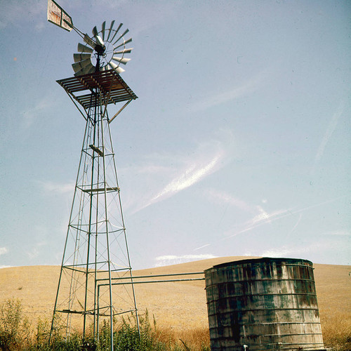 Water storage tank with windmill powered pump