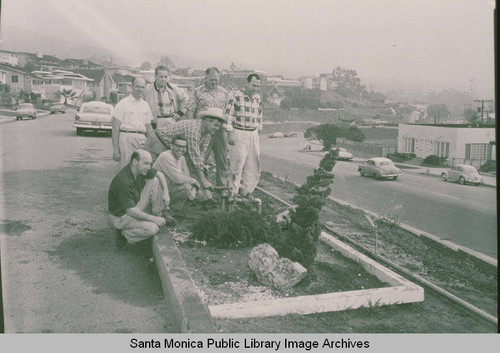 Group of men posing by the landscaping for Marquez Development