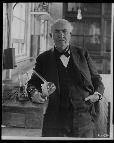 Thomas A. Edison in his workshop with light bulbs