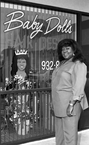 Baby Doll's beautician posing by the shop window, Los Angeles, 1989