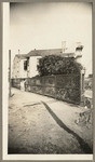 [Man standing next to lattice fence, side and back of house, San Francisco]