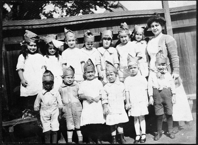 Group photograph of children wearing paper hats