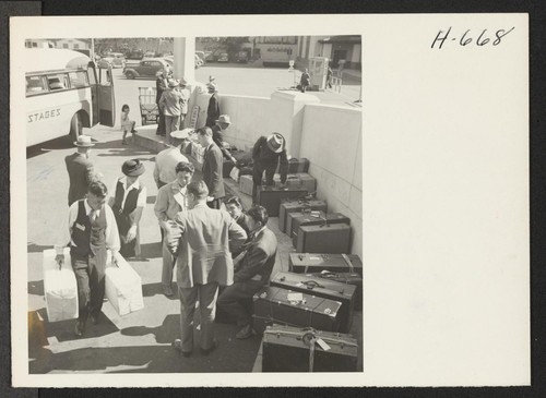Returnees arrive in Los Angeles by bus from Manzanar Relocation Center, some to resume residence in that city and others