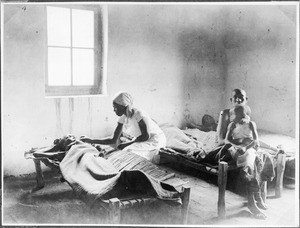 Nurse administering medicine, Gonja, Tanzania, ca.1927-1938