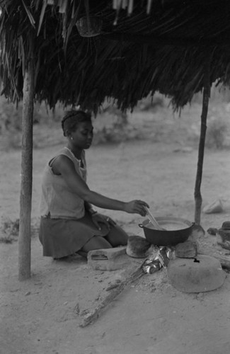 A young woman stirrs a pot, San Basilio de Palenque, 1977