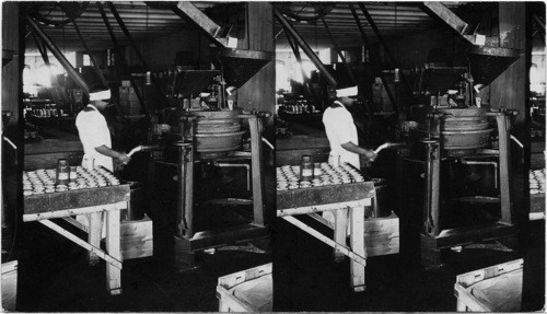 Peanut Butter mill for Grinding Peanuts into Butter, on top at left is Hoper containing Salt automatically fed with the Peanuts; discharged on Hopper at right. Makes 750 lbs. of Butter per hour