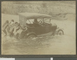 Car being pushed out of a river, Tumutumu, Kenya, ca.1921