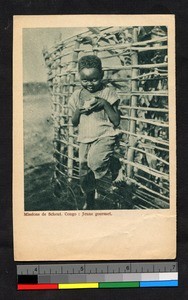 Young boy eating fruit, Congo, ca.1920-1940