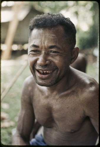 Smiling Mogiovyeka with teeth stained from chewing betel nuts