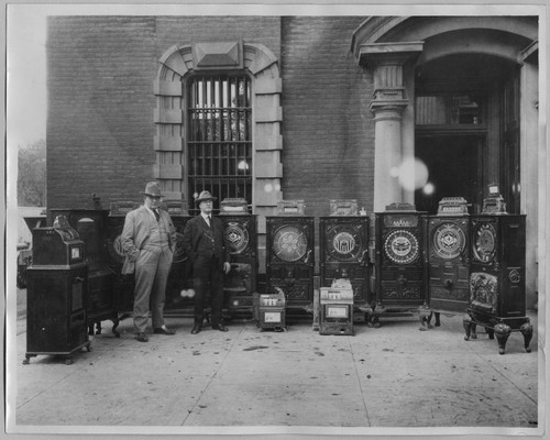 Sheriff George Lyle with confiscated slot machines [ca. 1925]