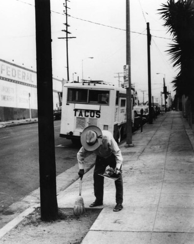 Man cleaning sidewalk