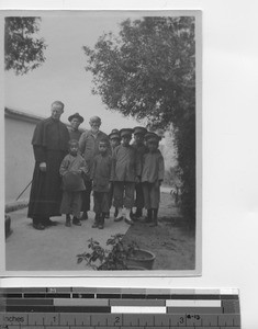 Maryknoll priest with boys at Hong Kong, China, 1925