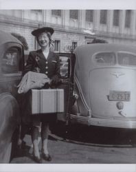 Maxine Kortum Durney standing with her suitcase, Berkeley, California, 1943