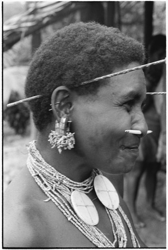 Oiru'a, wearing fio nose pin, 'ausakwalo earsticks, girigwei'a clamshell pendants, kwari'ingari nut and bat-tooth ear ornaments