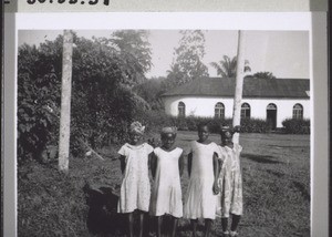 Four schoolgirls in front of the church